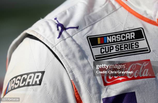 Detail view of the Jumpman logo on the suit of Denny Hamlin, driver of the FedEx Office Toyota, as he stands on the grid prior to the NASCAR Cup...