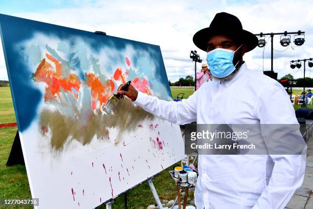 Demont Pinder, artist and historian, paints a live painting at Grandiosity Events 4th annual Polo & Jazz celebrity charity benefit hosted by Real...