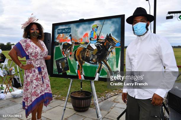Susan Smallwood, producer of Grandiosity Events Cigars & Guitars Charity Polo & Jazz charity event and Demont Pinder, artist and historian are seen...