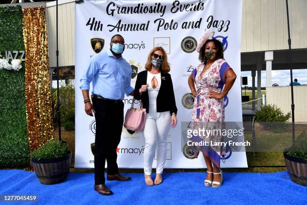 Rick Clark and Julie Bates of Macys, and Susan Smallwood, producer of Grandiosity Events Cigars & Guitars Charity Polo & Jazz charity event, appear...