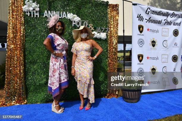 Susan Smallwood, producer of Grandiosity Events Cigars & Guitars Charity Polo & Jazz charity event, and Karen Huger of Housewives of Potomac and...