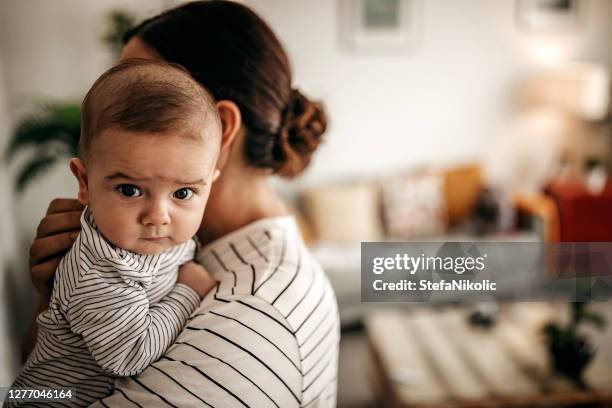 mother taking care of baby - babyhood stock pictures, royalty-free photos & images