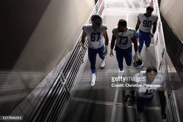 Running back D'Andre Swift of the Detroit Lions walks down the ramp with teammates following the NFL game against the Arizona Cardinals at State Farm...
