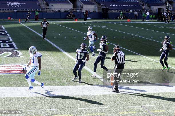 Cedrick Wilson of the Dallas Cowboys scores a 42 yard touchdown against the Seattle Seahawks during the third quarter in the game at CenturyLink...