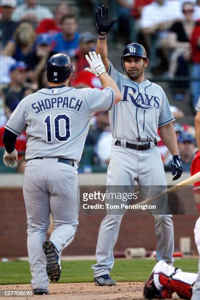 Kelly Shoppach of the Tampa Bay Rays is greeted by Johnny Damon as Shoppach heads toward the dugout after hitting a two-run home run in the in the...