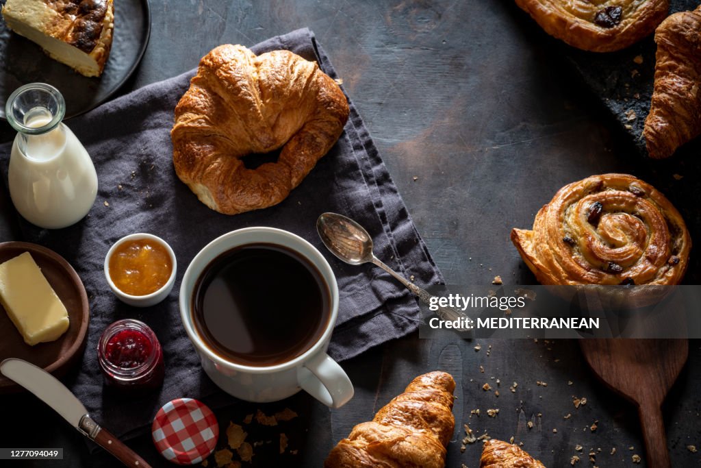 Coffee breakfast with pastries croissants, butter, cheesecake homemade