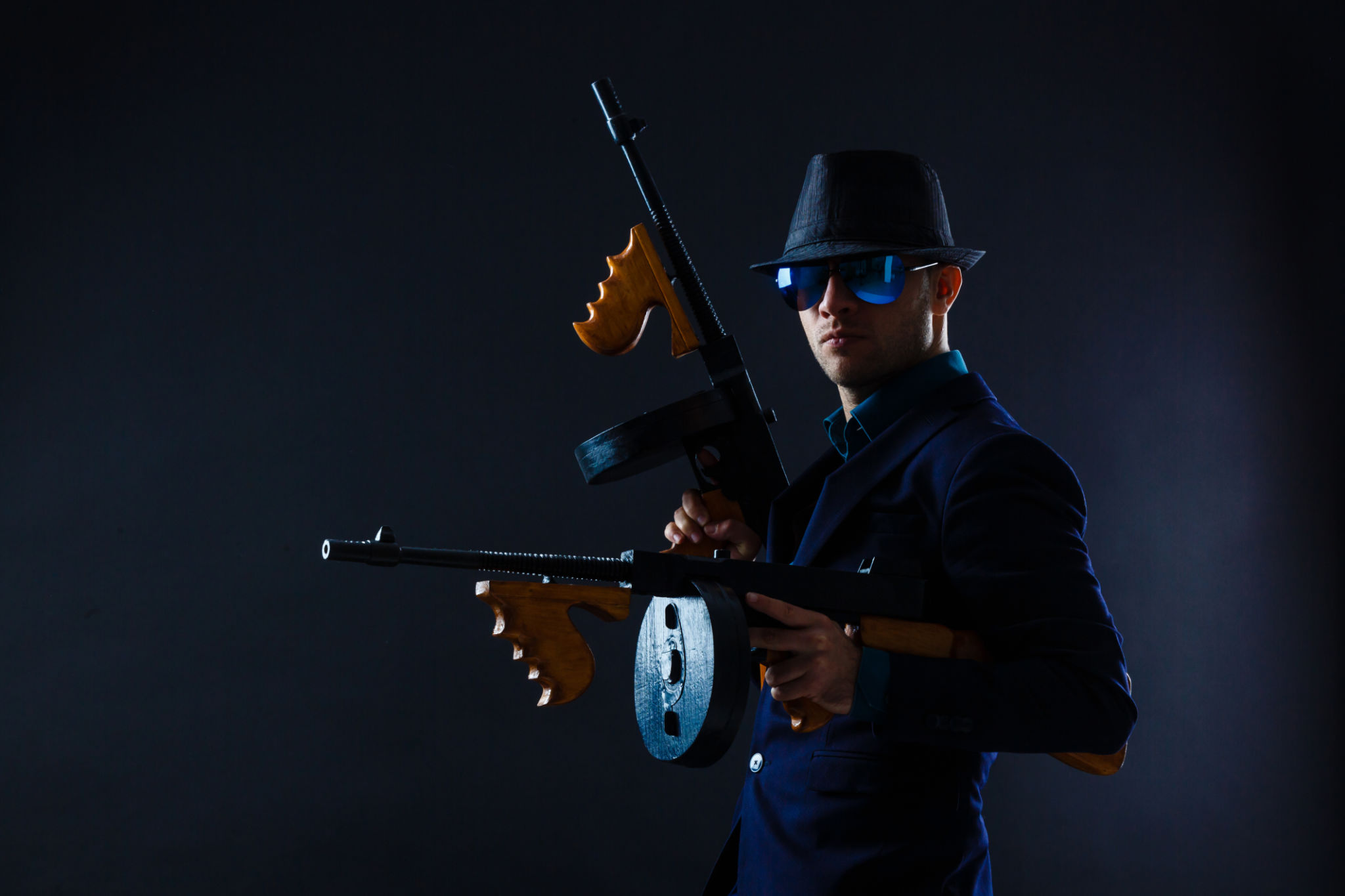 low key portrait of young gangster with hat in the darkness low key portrait of young gangster with hat in the darkness
