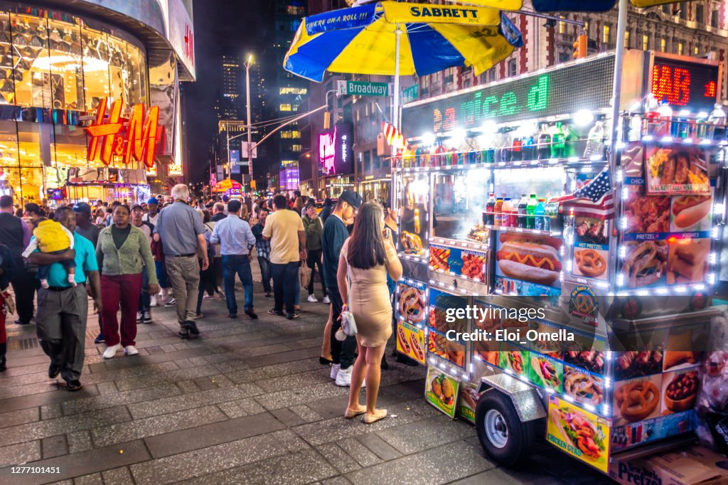 Vendor in its food truck at night in New York City, USA