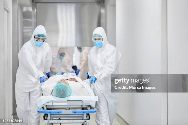 healthcare workers bringing patient on stretcher in hospital - ambulance arrival stock pictures, royalty-free photos & images