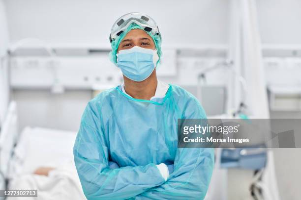 portrait of doctor in hospital ward during covid-19 - icu ward stock pictures, royalty-free photos & images