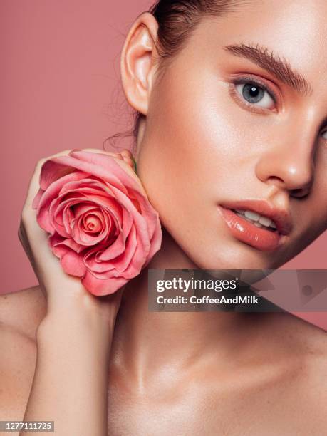 beautiful woman with pink rose - beautiful woman lipstick stock pictures, royalty-free photos & images