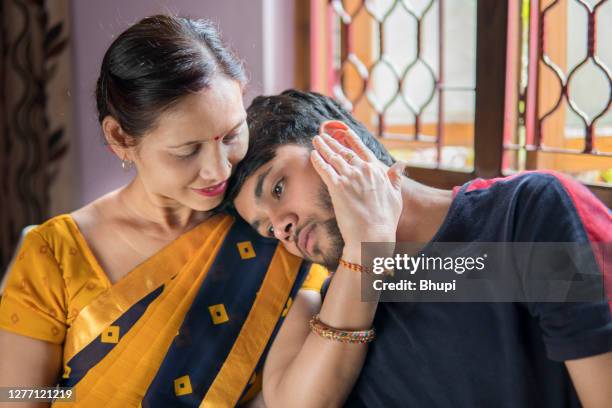 mother consoling her young adult son. - mother son stock pictures, royalty-free photos & images