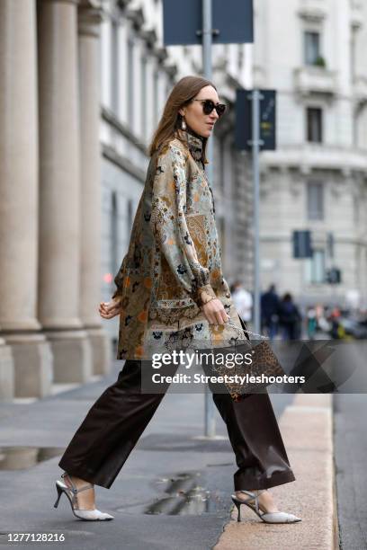 Influencer Annette Weber, wearing brown leather pants by Brunello Cucinelli, a gold colored Tunic with floral pattern by Etro, grey and silver pumps...