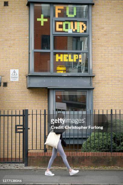 Signs made by students are displayed in a window of their locked down accommodation building on September 28, 2020 in Manchester, England. Around...