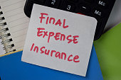 Final Expense Insurance text on sticky notes isolated on office desk.