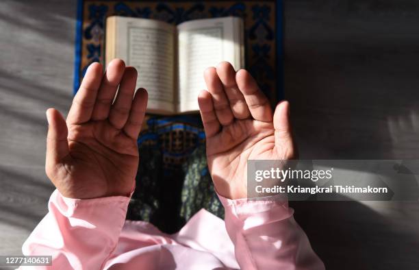 a muslim man is doing salah at home. - picture of allah stock pictures, royalty-free photos & images