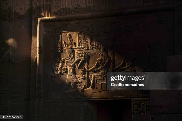 egyptian god and hieroglyphics on the wall - hieroglyphics stock pictures, royalty-free photos & images