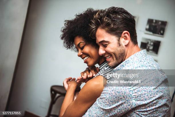close-up of romantic couple embracing while dancing in bar - embracing differences stock pictures, royalty-free photos & images