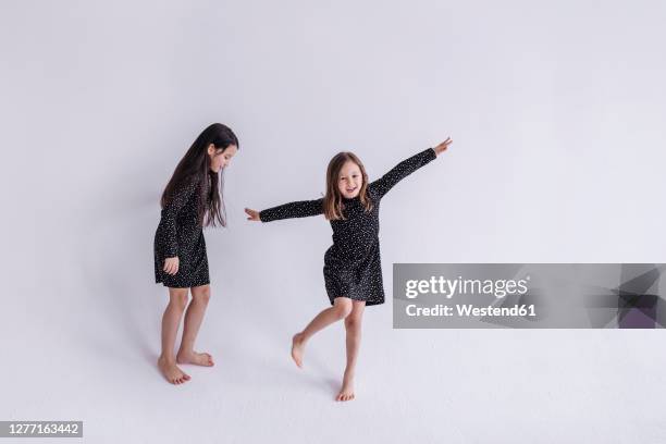 sibling playing against white background in studio - family photo shoot stock pictures, royalty-free photos & images