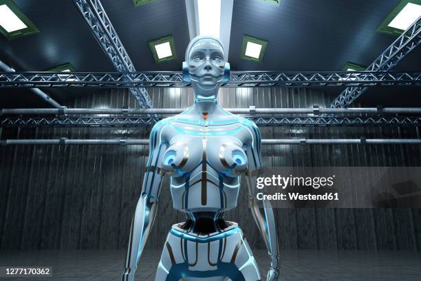 three dimensional render of gynoid standing inside empty warehouse - industrie porträt stock-grafiken, -clipart, -cartoons und -symbole