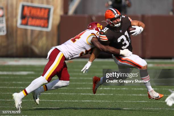 Andy Janovich of the Cleveland Browns tries to escape the tackle of Kevin Pierre-Louis of the Washington Football Team at FirstEnergy Stadium on...