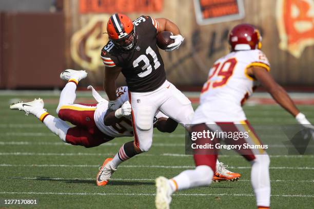 Andy Janovich of the Cleveland Browns tries to escape the tackle of Kevin Pierre-Louis of the Washington Football Team at FirstEnergy Stadium on...