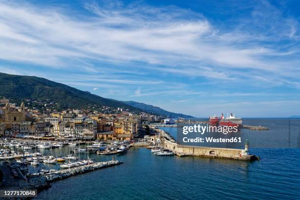 france, haute-corse, bastia, harbor of coastal town with cruise ship in background - haute corse stock pictures, royalty-free photos & images