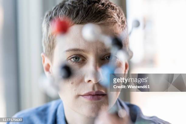 portrait of woman with molecule model - selective focus stock-fotos und bilder