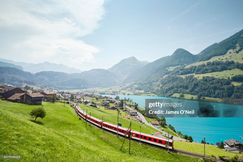 Lush Swiss landscape with commuter train and lake, Lungern, Obwalden, Switzerland