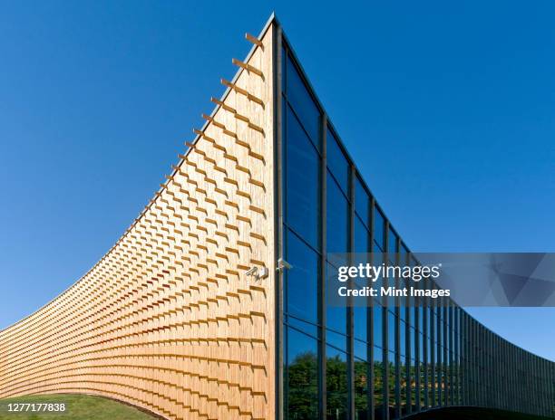 modern building, wooden beams projecting from a curved wood cladding wall - estonia stock pictures, royalty-free photos & images