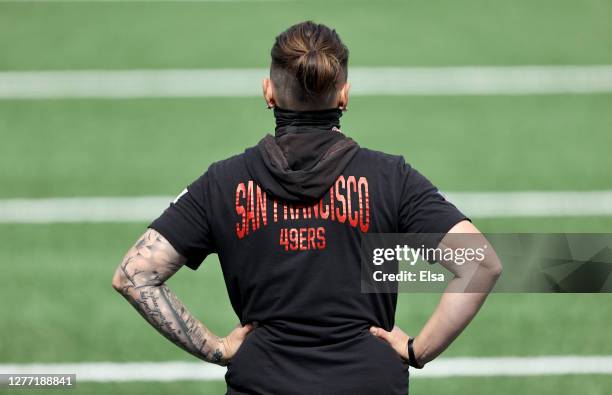 Offensive assistant Katie Sowers of the San Francisco 49ers watches her players during warm ups before the game against the New York Giants at...