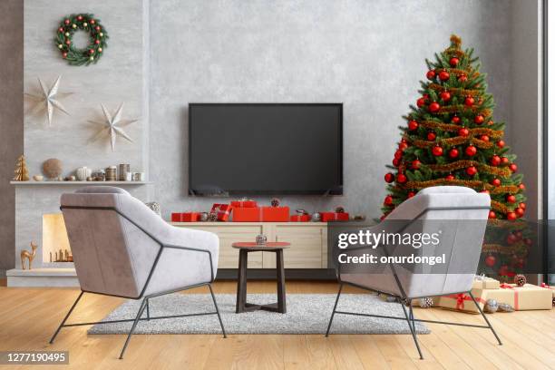 smart tv mockup with blank screen in modern living room with armchairs, christmas tree and gift boxes - smart tv living room stock pictures, royalty-free photos & images