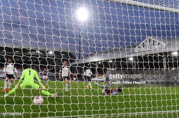 Tyrone Mings of Aston Villa scores his team's third goal past Alphonse Areola of Fulham during the Premier League match between Fulham and Aston...