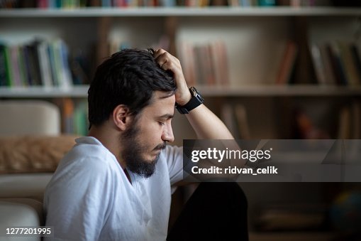 Unhappy depressed caucasian male sitting Unhappy depressed caucasian male sitting