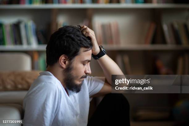 unhappy depressed caucasian male sitting - loneliness coronavirus stock pictures, royalty-free photos & images