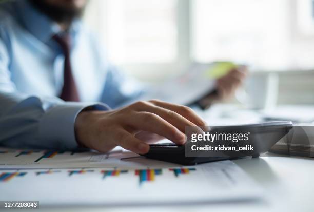 business accounting concept, business man using calculator with computer laptop, budget and loan paper in office. - economy stock pictures, royalty-free photos & images