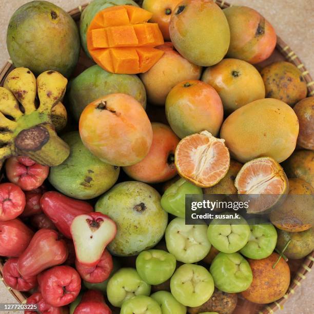 high angle view of various tropical fruits on a basket. - water apples stock pictures, royalty-free photos & images