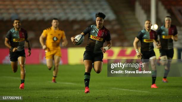 Marcus Smith of Harlequins breaks away to score a try during the Gallagher Premiership Rugby match between Harlequins and Wasps at Twickenham Stoop...