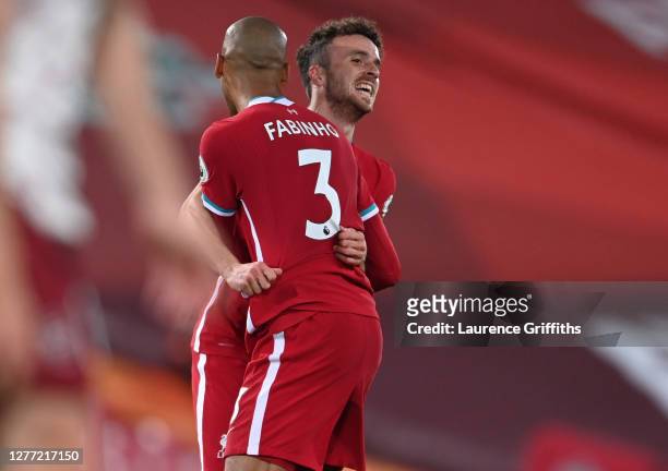 Diogo Jota of Liverpool celebrates with teammate Fabinho after scoring his sides third goal during the Premier League match between Liverpool and...