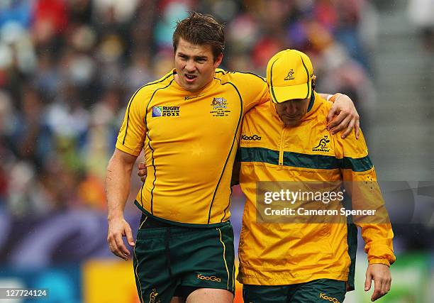 Drew Mitchell of the Wallabies leaves the pitch injured during the IRB 2011 Rugby World Cup Pool C match between Australia and Russia at Trafalgar...