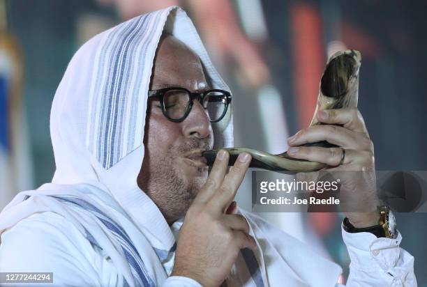 Rabbi Guido Cohen blows into a shofar as he leads a drive-in Yom Kippur service put on by Aventura Turnberry Jewish Center at the Dezerland Park on...