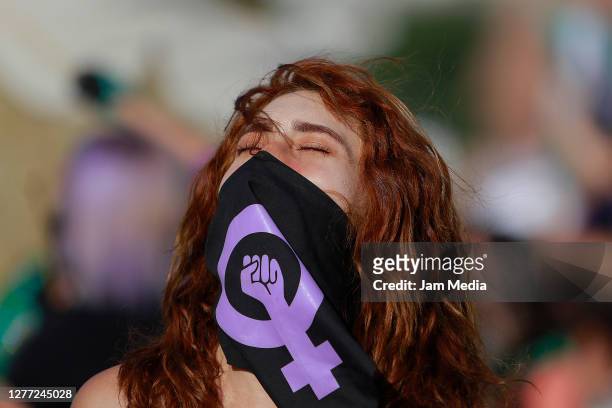 Protester wearing a face mask looks on during a demonstration in favor of decriminalization of abortion on the International Safe Abortion Day on...