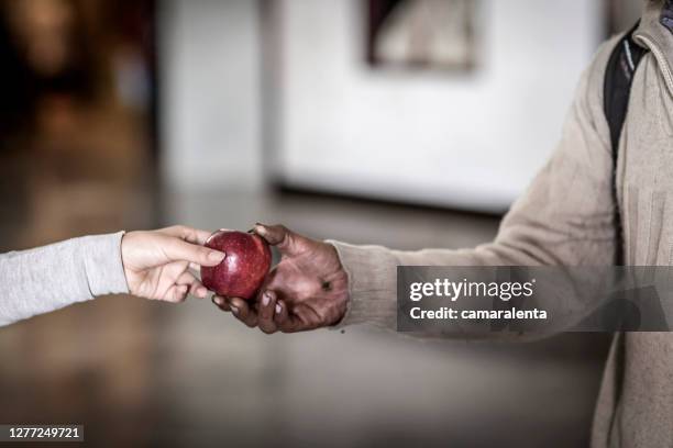 Detail of hand of homeless woman asking for money in the street
