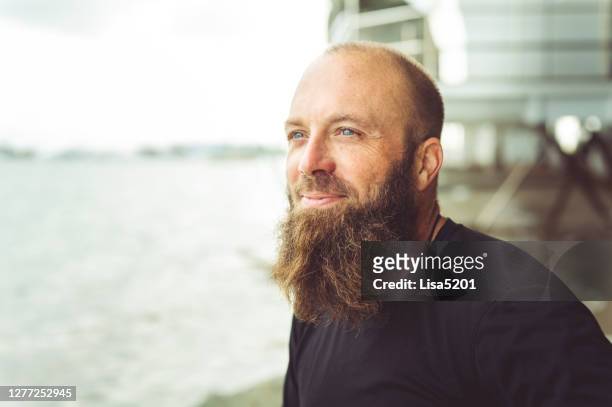 man with beard at the beach looking off into the distance - positive thinking stock pictures, royalty-free photos & images