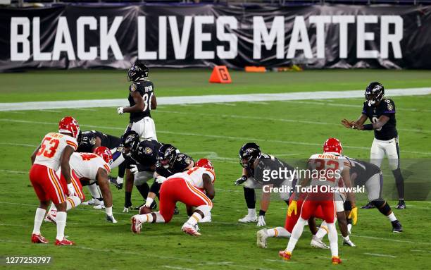 Lamar Jackson of the Baltimore Ravens waits for the snap in front a sign that reads "Black Lives Matter" against the Kansas City Chiefs at M&T Bank...