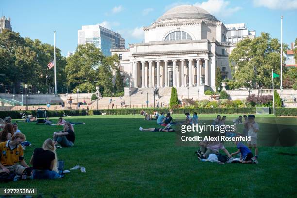 People sit on the grass at Columbia University as the city continues Phase 4 of re-opening following restrictions imposed to slow the spread of...