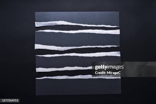 torn black paper stripes with white edge - tearing stock-fotos und bilder