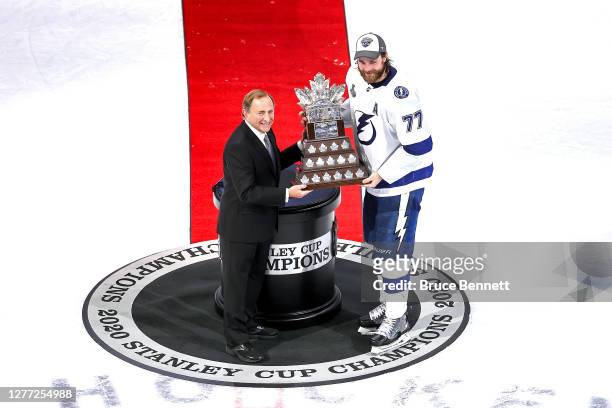 Commissioner Gary Bettman presents Victor Hedman of the Tampa Bay Lightning with the Conn Smythe Trophy for playoff MVP following the Lightning’s...