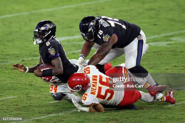 Ben Niemann and Taco Charlton of the Kansas City Chiefs tackle Lamar Jackson of the Baltimore Ravens during the fourth quarter at M&T Bank Stadium on...