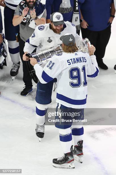 Steven Stamkos of the Tampa Bay Lightning hands off the Stanley Cup to Victor Hedman following the series-winning victory over the Dallas Stars in...